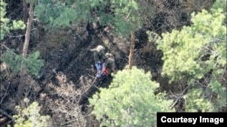 Брус и друг войник държат руско знаме, след като са превзели позиция на руснаците в Донецк