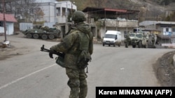 A Russian peacekeeper stands guard on a road in the town of Lachin (file photo).