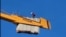 Tajik migrant on crane 