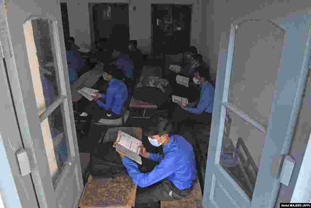 Students wearing face masks attend a class at a school in Peshawar, Pakistan, on September 15.