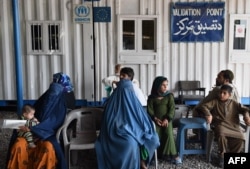 Afghan refugees wait at the UNHCR registration center in the Pakistani city of Peshawar in June.