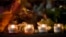 Candles are lit for those who died in the Boston Marathon bombings and the subsequent police manhunt at a memorial on Boylston Street in Boston on April 21.