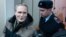 RUSSIA -- Dennis Christensen is escorted inside a courthouse following the verdict announcement in the town of Oryol, February 6, 2019