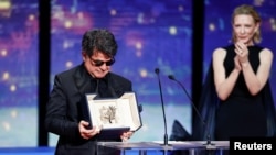 Iranian filmmaker Jafar Panahi holds the Palme d'Or at Cannes after receiving the prestigious award from actress Cate Blanchett on May 24.