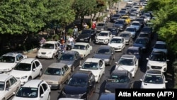 Vehicles wait in traffic as residents flee Tehran on June 15.