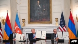 Ադրբեջանի նախագահ Իլհամ Ալիևը, ԱՄՆ նախագահ Դոնալդ Թրամփը և Հայաստանի վարչապետ Նիկոլ Փաշինյանը ցուցադրում են ստորագրված համաձայնագիրը