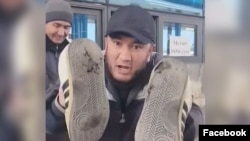 Өзбекстандагы энергокризисти сындап, бийликке таманы тешилген бут кийимин көрсөткөн Гайрат Дустов. 