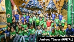 Copii cu diverse dizabilități și instructori Climb Again pozează la finalul petrecerii de Crăciun, organizată la sala de escaladă Galactic Gym din București.