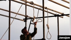 A soldier prepares the ropes for a public hanging in Iran. (file photo)