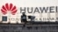 A surveillance camera is seen in front of a Huawei logo in Belgrade, Serbia. (File photo)