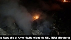 A handout picture from the Armenian Emergency Situations Ministry showing what is said to be the crash site following the downing of the Russian helicopter. 