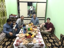 Reporter Matthew Luxmoore (right) with Abdukholik Gadoev, his friends Azam and Ismail, and one of his many grandchildren.
