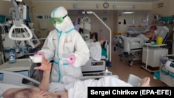A medical-student volunteer takes care of a patient at an intensive-care unit at a Moscow hospital. 