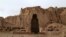 Afghan boys play soccer in front of the empty seat of one of two Buddha statues destroyed by the Taliban in 2001 in Bamiyan Province.