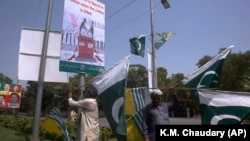 Pakistani and Kashmiri flags are displayed around Lahore, Pakistan, ahead of nationwide anti-India protests. 