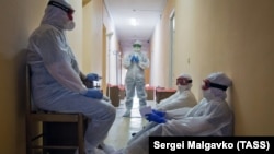 Медики в защитных костюмах, иллюстративное фото.