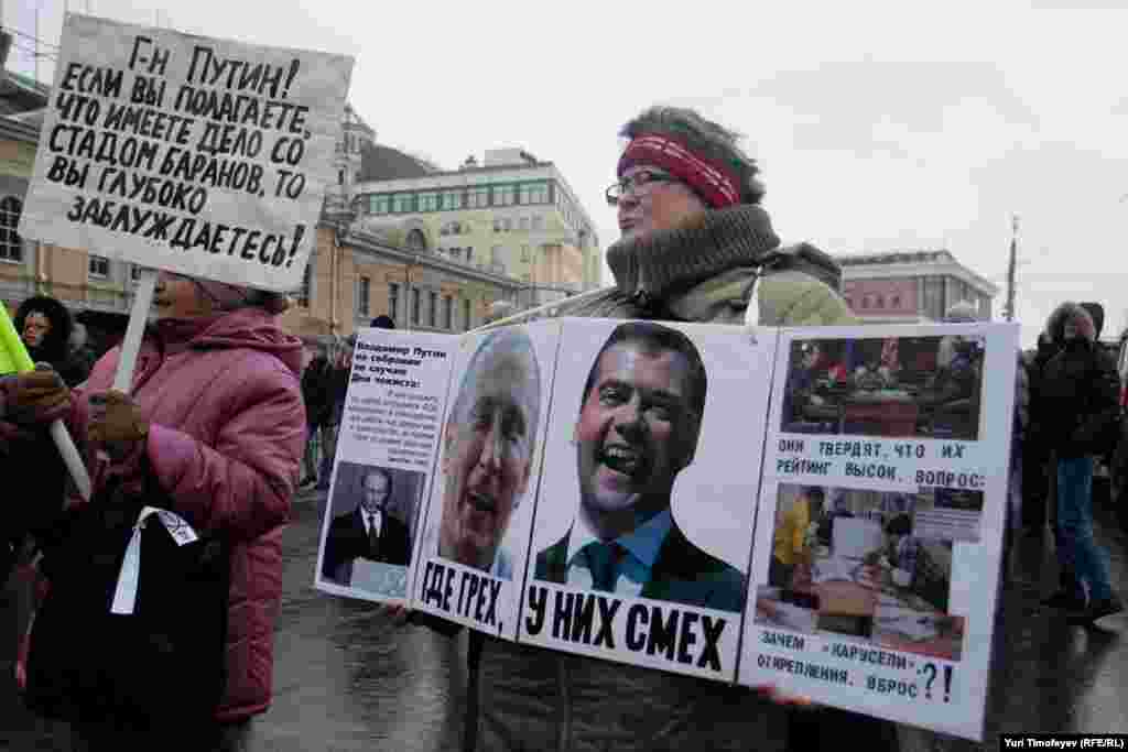 "Where there's sin, they laugh" alongside images on Vladimir Putin and Dmitry Medvedev.
