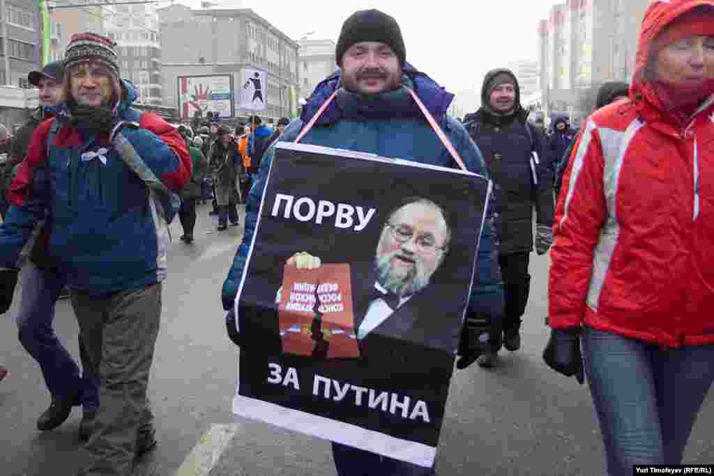 Central Election Commission head Vladimir&nbsp;Churov is pictured ripping up the constitution saying, "I tear up for Putin," a reference to the Putin Army -- attractive young women who tear off their clothes for Putin. 