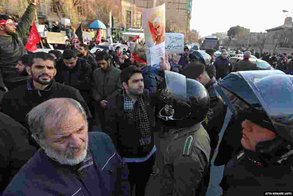Iranian demonstrators hold posters bearing the image of slain military commander Qasem Soleimani in front of the British Embassy in Tehran on January 12. About 200 protesters chanted "Death to Britain" as they rallied outside the mission. The day before, British Ambassador Rob Macaire was briefly arrested for attending a memorial for the victims of&nbsp;Ukraine International Airlines Flight PS752.
