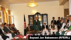 Afghan President Hamid Karzai (second left) speaks with members of the new Afghan Peace Council during its inaugural session in Kabul.