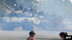 Russian tanks move through Tskhinvali, the capital of South Ossetia, soon after Russia's August war with Georgia.