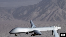 A MQ-1 Predator drone aircraft in flight at an undiclosed location.