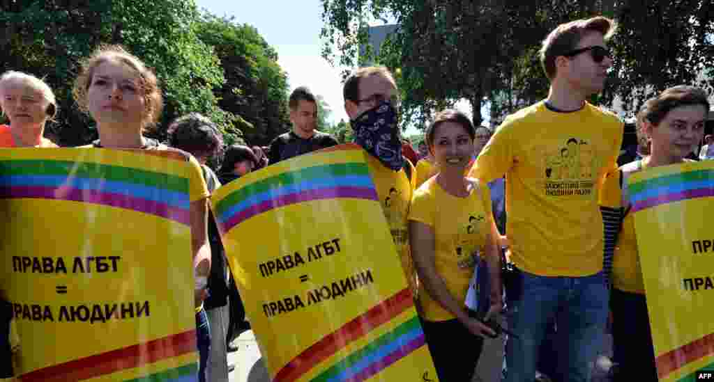 Activists carry placards saying "Lesbian and gay rights are human rights" during the gay-pride parade in the Ukrainian capital.&nbsp;