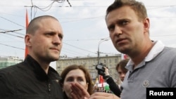 Sergei Udaltsov (left) and Aleksei Navalny speak at the May 6 opposition rally.