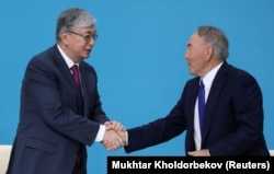 Interim Kazakh President Qasym-Zhomart Toqaev (left) and longtime President Nursultan Nazarbaev attend a congress of the Nur Otan ruling party in the capital, Nur-Sultan, on April 23.