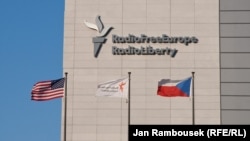 აშშ-ის RFE/RL-ისა და ჩეხეთის დროშები რადიო თავისუფალი ევროპა / რადიო თავისუფლების ოფისის ფონზე პრაღაში