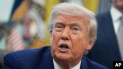 President Donald Trump speaks to reporters in the Oval Office of the White House, May 23, 2025