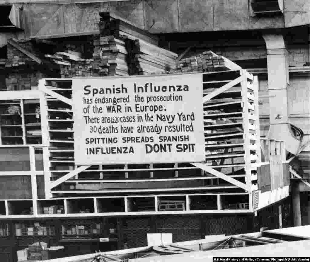 На плакате написано, что не надо плевать на землю. Надпись вывесили в октябре 1918 года как раз на входе на тот самый завод морской авиации. Из всех городов США Филадельфия пострадала от "испанки" больше всего.