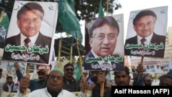 Supporters of the All Pakistan Muslim League (APML), the party of former military ruler Pervez Musharraf, carry placards during a protest following his conviction in a treason case on December 17.