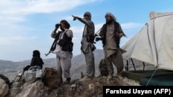 Afghan militia fighters keep watch for Taliban insurgents at an outpost in Afghanistan's Balkh Province.