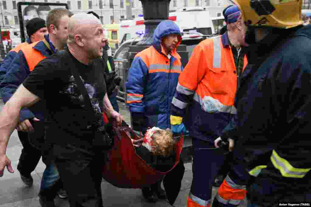 An injured person is helped by emergency services outside the Sennaya Ploshchad subway station.
