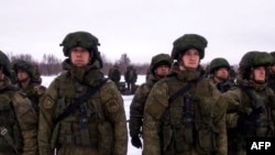 Russian paratroopers board a military cargo plane to depart to Kazakhstan as part of a CSTO mission in the restive Central Asian country. 