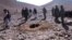 A RFE/RL video grab shows Afghan men stoning Afghan woman Rokhsana (C, in hole) to death in Ghalmeen, Afghanistan's Ghor province. Local officials say the incident happened in October. 