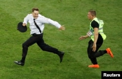 Verzilov is chased by a steward after he and other Pussy Riot members -- dressed in police uniforms -- ran onto the pitch during the World Cup final in Moscow on July 15.