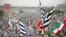 Supporters of opposition political parties wave party flags in Islamabad on November 1.