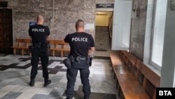 Полицаи чакат във фоайето пред залата на Апелативния съд във Велико Търново, в която 13 часа бяха разглеждани мерките за неотклонение на четиримата тийнейджъри, обвиняеми за побоя над директора на полицията в Русе, 12 септември 2025 г.