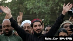 PTM leader Manzoor Pastheen (center) waves to supporters at a Lahore rally in April.