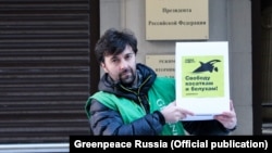 A Russian Greenpeace activist protests the plight of the whales near the presidential administration.