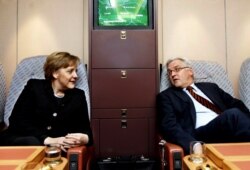 Kansler Merkel we ýurduň daşary işler ministri bolan Frank-Walter Ştaýnmaýer hökümet uçarynyň içinde otyrlar. 2006 ý.