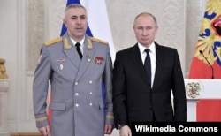 General Rustam Muradov (left) with Russian President Vladimir Putin. (file photo)