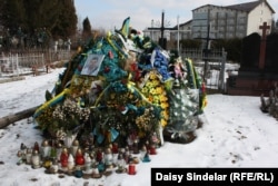 The grave of 27-year-old Ukrainian Army soldier Taras Dorosh in Malekhiv, his home village in the Lviv region. Dorosh died far from home after being shot by a sniper during heavy fighting against pro-Russian forces in eastern Ukraine.