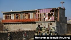 Afghan security forces inspect the site of an attack in a U.S. military air base in Bagram, north of Kabul on December 11.