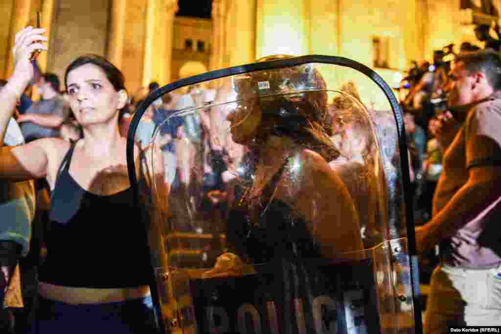 Protesters with police shields.&nbsp;