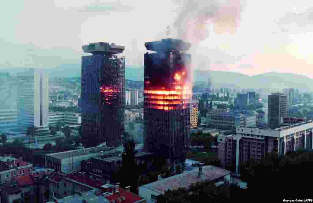 A tower burns in downtown Sarajevo on June 8, 1992, as paramilitary groups in the surrounding hills fire mortars and artillery down on the blockaded city.