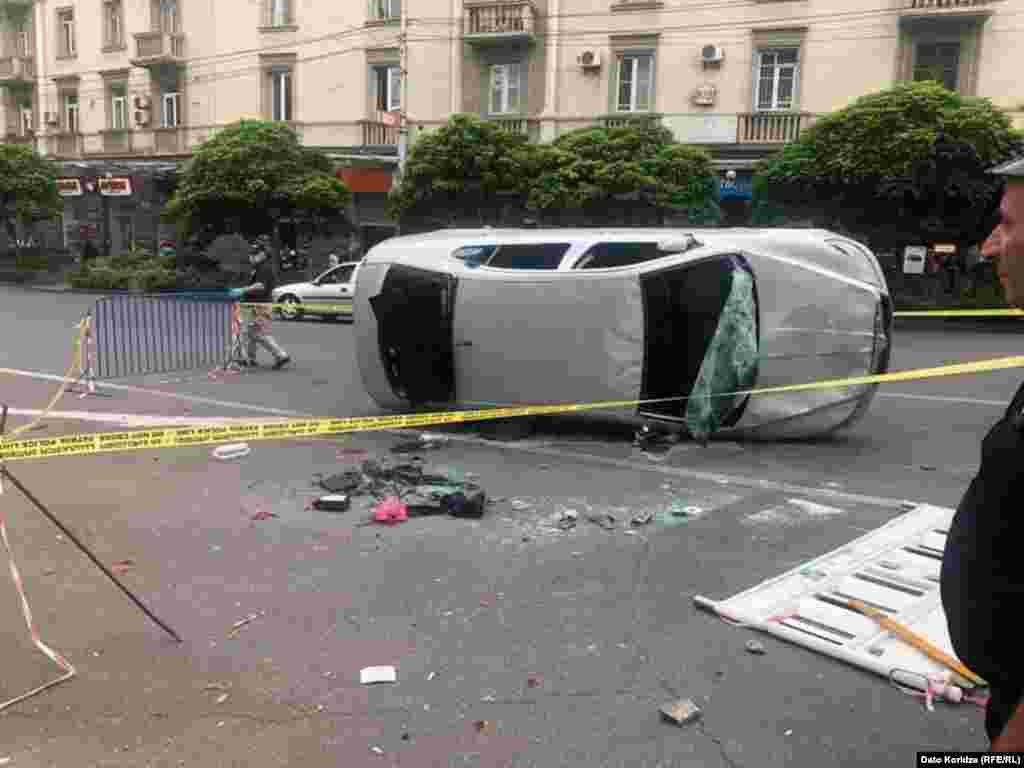 An overturned car as day breaks in Tbilisi on June 21. Opposition politician Grigol Vashadze vowed&nbsp;&ldquo;We will meet again on Rustaveli Avenue at 19:00 [on June 21].&nbsp;We will need to agree on an action plan with people."