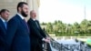 Azerbaijani President Ilham Aliyev (right) and Syria's interim president, Ahmad al-Sharaa, stand on a balcony during their meeting in Baku on July 12